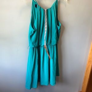 Strapped green polyester dress with white and black belt size l.